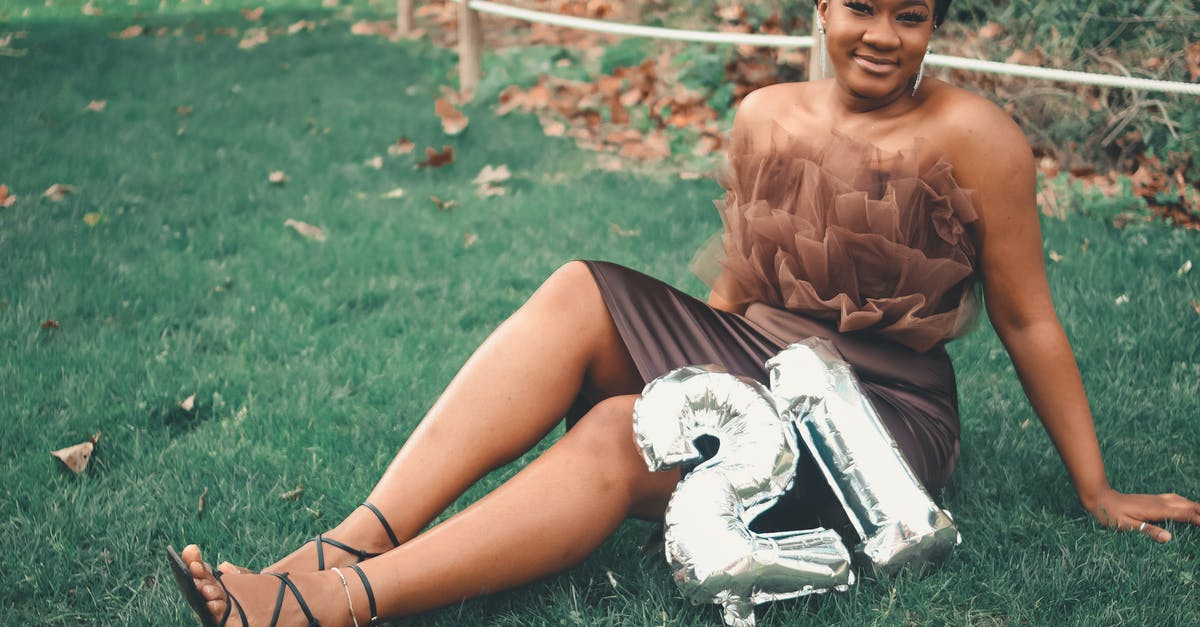 Vegemite in a tube? - Woman in Brown Tube Dress Sitting on Green Grass Field Vegemite in a tube? - Woman in Brown Tube Dress Sitting on Green Grass Field