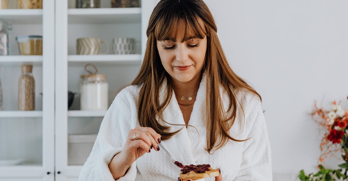 Vietnamese Sandwiches - Spread Identification? - A Woman Putting a Jam on the Bread Vietnamese Sandwiches - Spread Identification? - A Woman Putting a Jam on the Bread