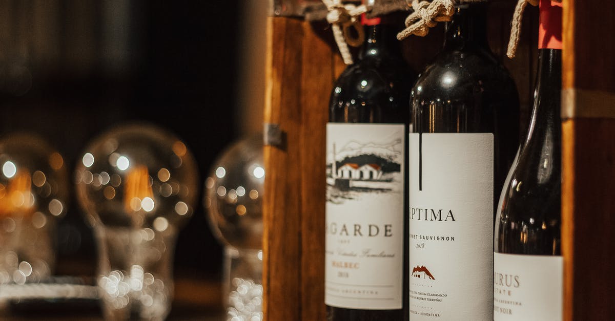 Warming refrigerated butter at a table in a restaurant - Bottles of wine in wooden box arranged on table Warming refrigerated butter at a table in a restaurant - Bottles of wine in wooden box arranged on table