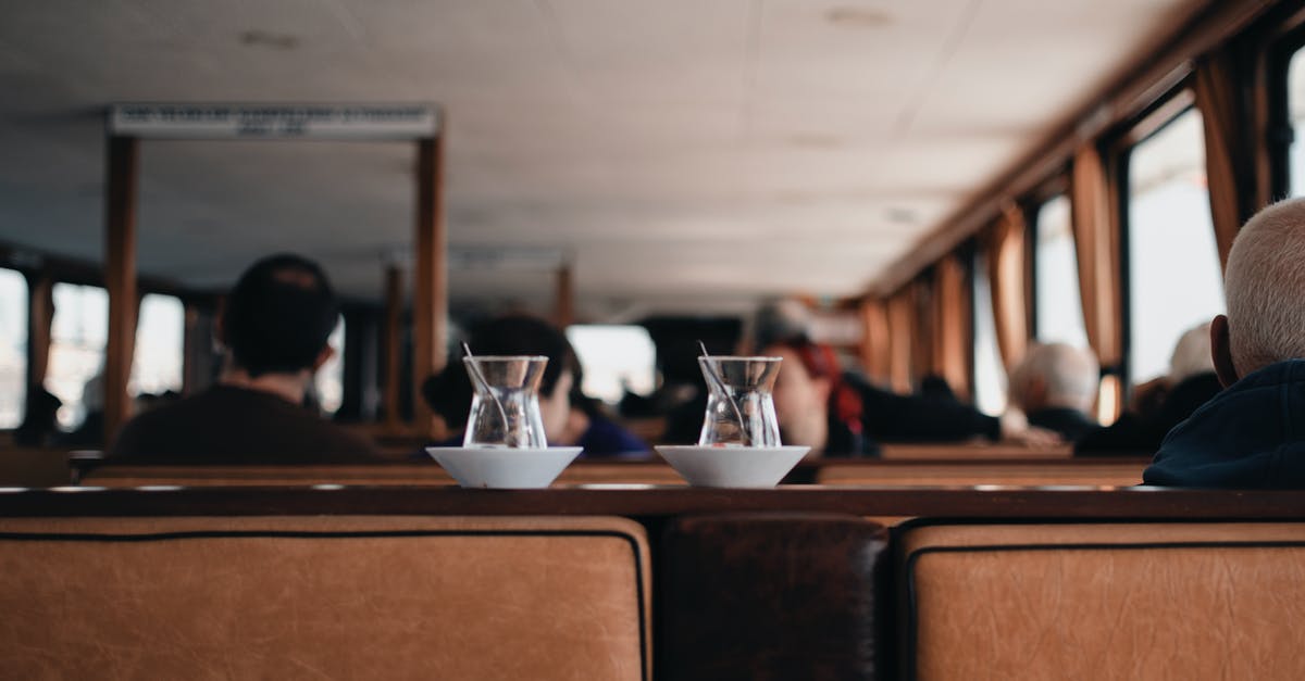 Warming refrigerated butter at a table in a restaurant - Small Middle East tea glass on ceramic saucers placed on wooden shelf in cozy cafe Warming refrigerated butter at a table in a restaurant - Small Middle East tea glass on ceramic saucers placed on wooden shelf in cozy cafe