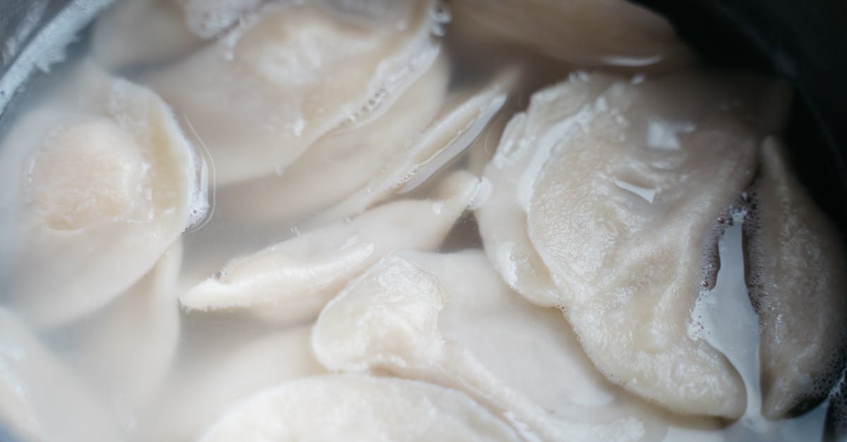 Ways to displace liquids while cooking - Close-up Shot of Dumplings in the Water Ways to displace liquids while cooking - Close-up Shot of Dumplings in the Water