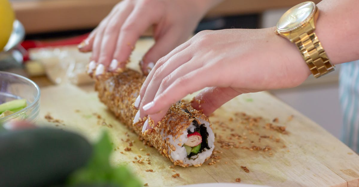 What's some safe advice for a beginner for making sushi? [duplicate] - Photo of a Person's Hands Making Sushi