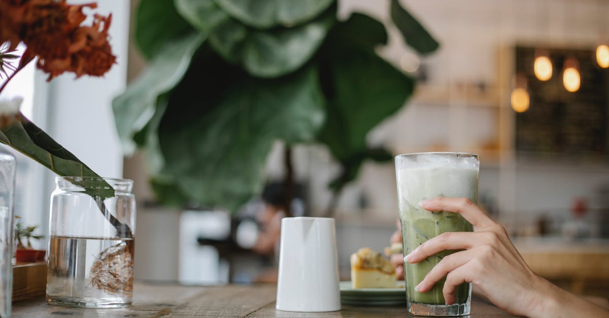 What's the best method for making iced coffee? - Photo of Person Holding a Glass of Iced Matcha Latte