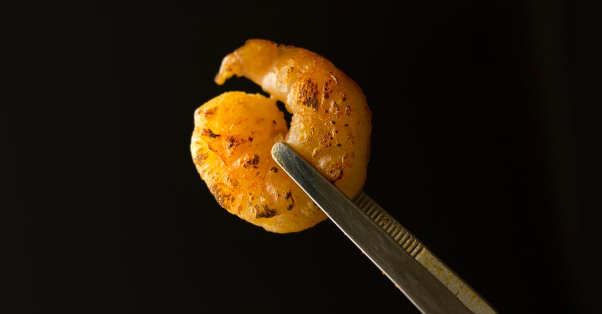 What's the best way to reheat grilled shrimp - Breaded Shrimp on Black Background