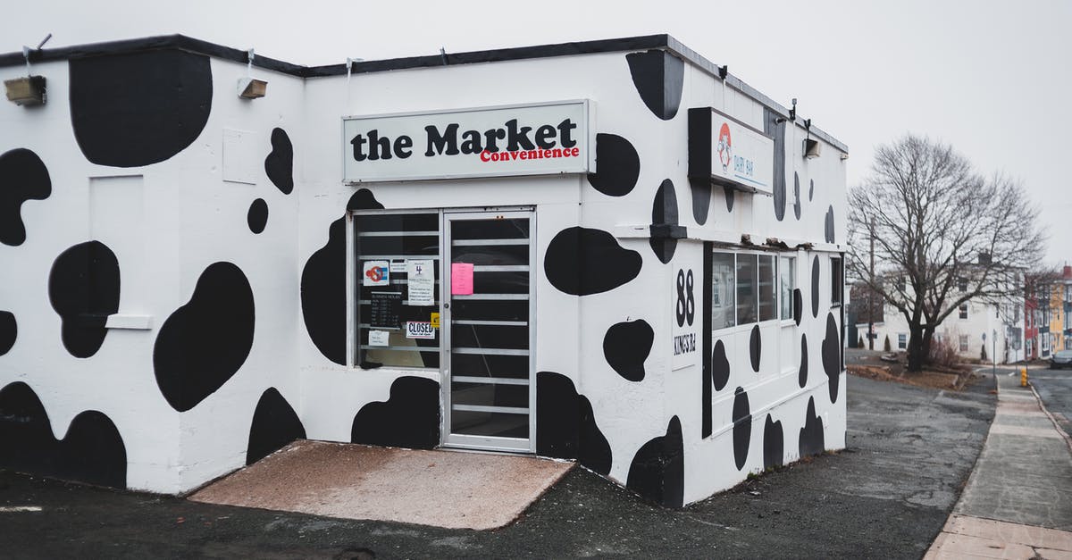 What's the best way to store unused sushi rice? - Store with creative cow pattern and signboard located on asphalt sidewalk on street with buildings and leafless trees in town