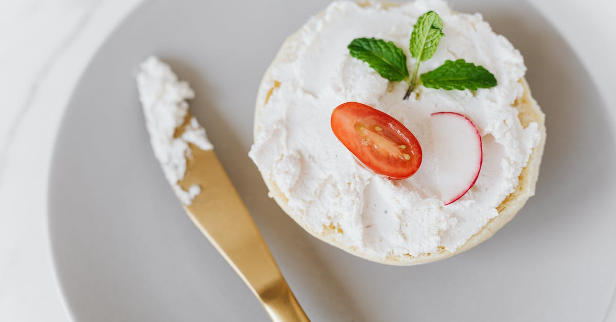 What's the point of "cheese alternative" that has dairy in it? - From above of delicious cottage cheese spread on bun decorated with vegetables and mint on round platter with golden knife placed on marble table What's the point of "cheese alternative" that has dairy in it? - From above of delicious cottage cheese spread on bun decorated with vegetables and mint on round platter with golden knife placed on marble table