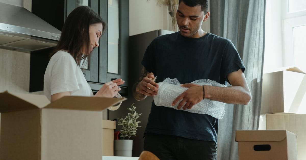 What's the trick to wrapping tightly in plastic wrap? - Man in Blue Crew Neck T-shirt Holding Woman in White Long Sleeve Shirt What's the trick to wrapping tightly in plastic wrap? - Man in Blue Crew Neck T-shirt Holding Woman in White Long Sleeve Shirt