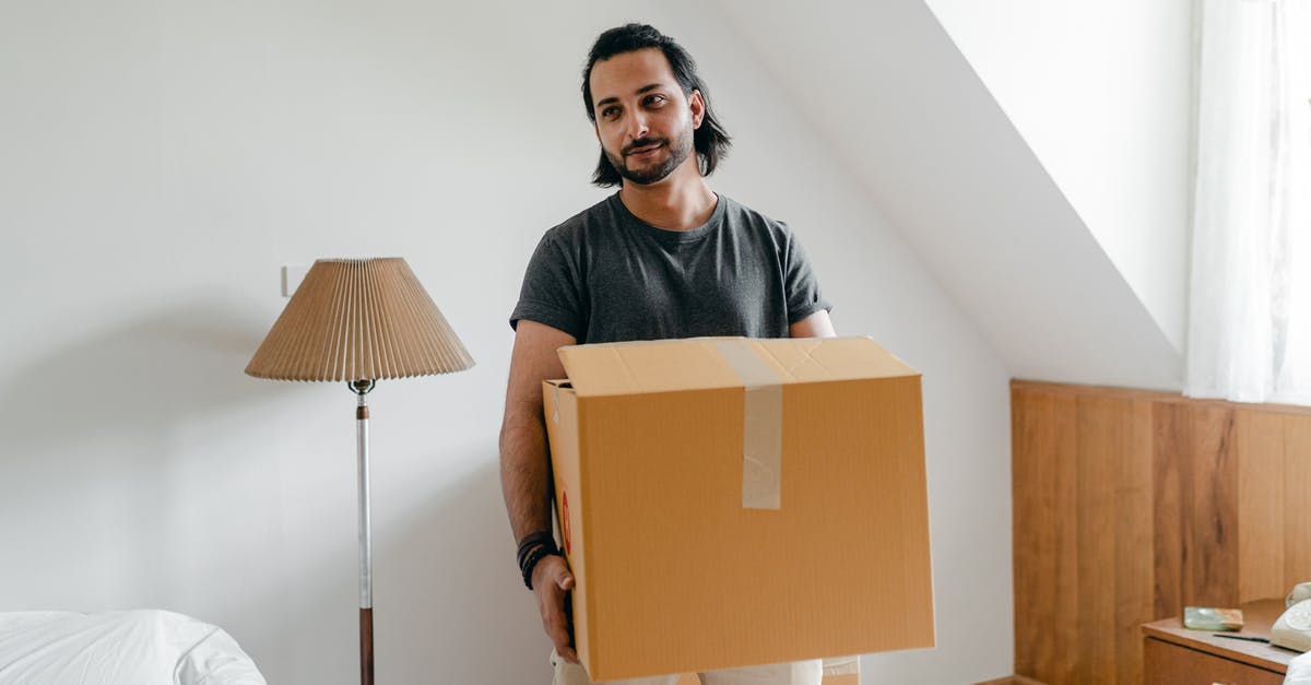 What's this odd stuff coming out of my meringue? - Cheerful young bearded male in casual wear carrying cardboard container in sunny bedroom while moving into new apartment What's this odd stuff coming out of my meringue? - Cheerful young bearded male in casual wear carrying cardboard container in sunny bedroom while moving into new apartment