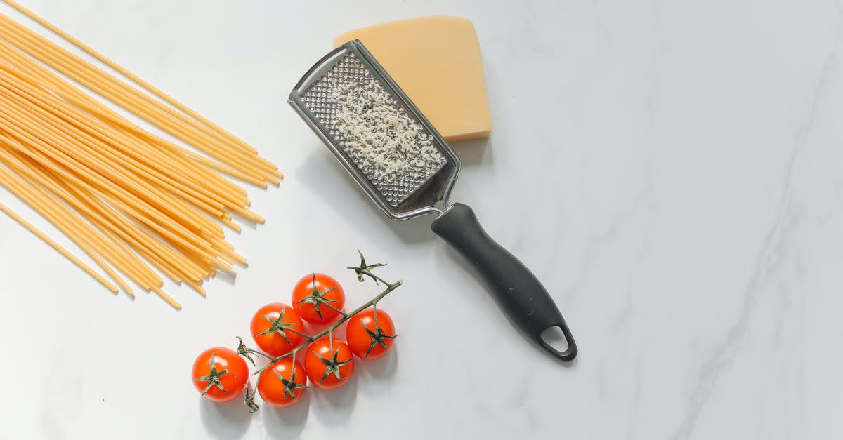 What's this "pucker" style hole on my cheese grater for? - Cheese with Grater Beside Spaghetti and Tomatoes What's this "pucker" style hole on my cheese grater for? - Cheese with Grater Beside Spaghetti and Tomatoes
