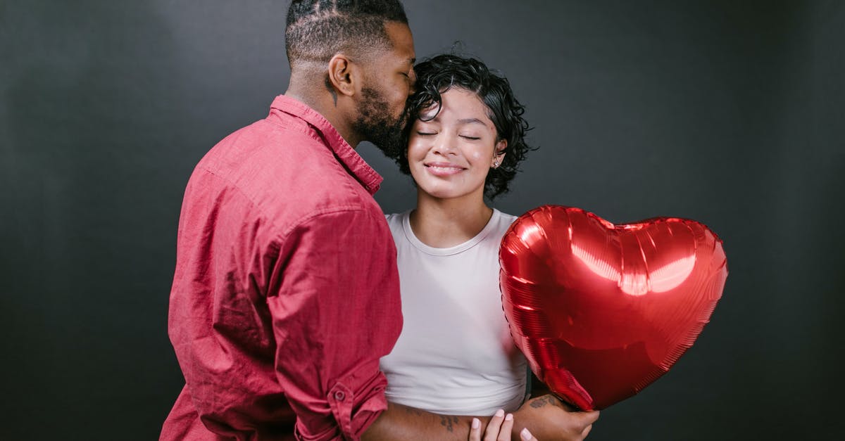 What's wrong with my oven? - Man Kissing His Woman While Holding a Red Heart Shaped Balloon What's wrong with my oven? - Man Kissing His Woman While Holding a Red Heart Shaped Balloon