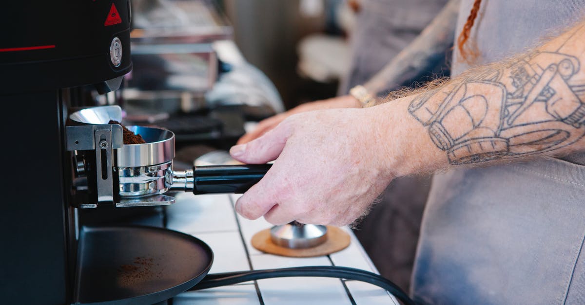 What are convenient and reliable ways to make the starter for rye bread? - Tattooed man preparing coffee with coffee machine