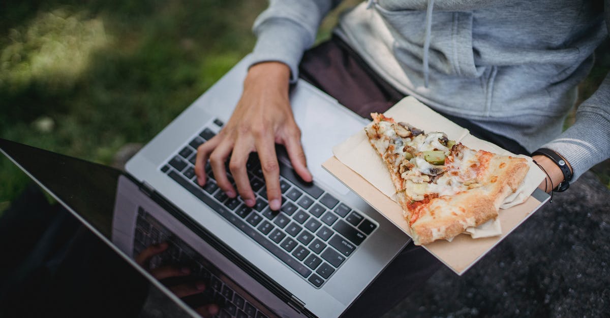 What are good resources to learn food chemistry? - From above of crop anonymous learner using laptop for studies and eating pizza in park What are good resources to learn food chemistry? - From above of crop anonymous learner using laptop for studies and eating pizza in park