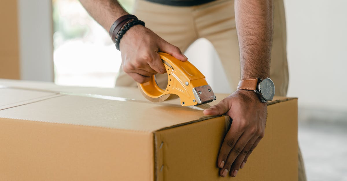 What are good techniques to prepare liver? - Crop faceless young male with wristwatch using adhesive tape while preparing cardboard box for transportation What are good techniques to prepare liver? - Crop faceless young male with wristwatch using adhesive tape while preparing cardboard box for transportation