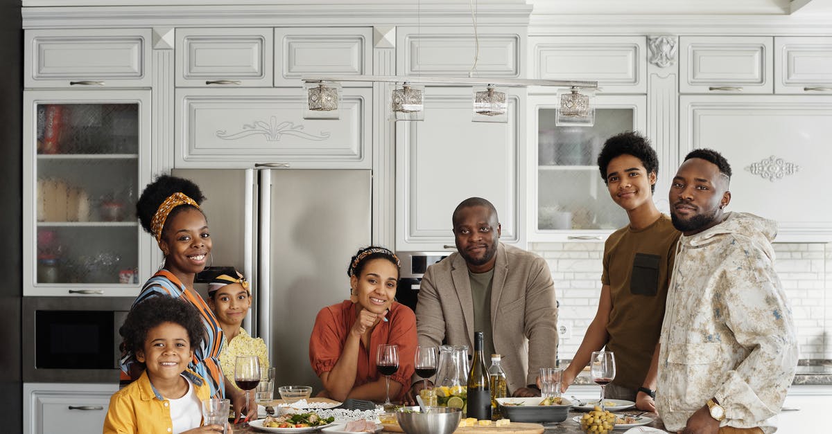 What are some kid-friendly dishes from Kenya? - Family Posing for a Photo in the Kitchen What are some kid-friendly dishes from Kenya? - Family Posing for a Photo in the Kitchen