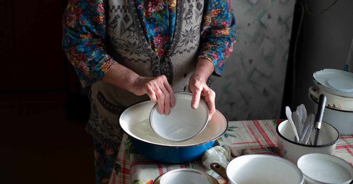 What are the consequences of not rinsing hermetic lentils prior to use? - A Person Rinsing a Bowl with Water from a Stainless Steel Basin What are the consequences of not rinsing hermetic lentils prior to use? - A Person Rinsing a Bowl with Water from a Stainless Steel Basin