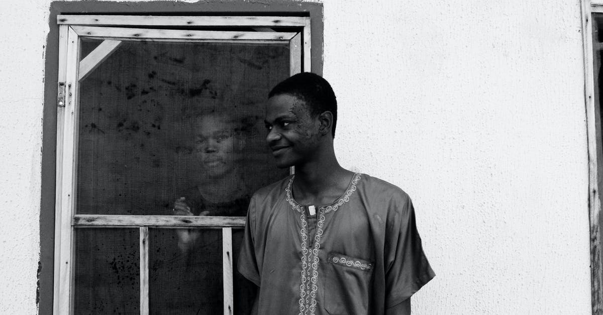 What are the difference between outside and inside skirt steak? - Black and white of slim happy African American guy looking away while standing near house with concrete walls and old window with serious partner inside building What are the difference between outside and inside skirt steak? - Black and white of slim happy African American guy looking away while standing near house with concrete walls and old window with serious partner inside building