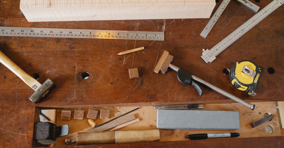 What are the different applications for differently shaped wooden spoons? - Top view of various equipment for joinery and measuring placed on timber table What are the different applications for differently shaped wooden spoons? - Top view of various equipment for joinery and measuring placed on timber table