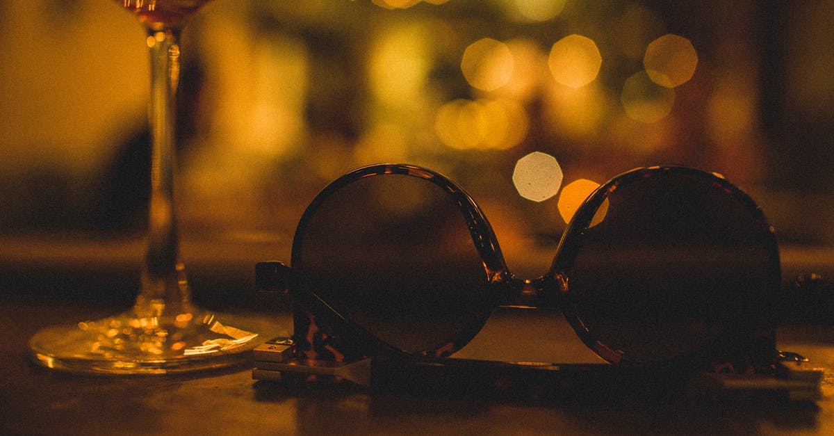 What are the natural and artificial sugars? - Composition of glass with refreshing drink on thin leg near modern sunglasses for women in plastic frame on wooden table in restaurant at night What are the natural and artificial sugars? - Composition of glass with refreshing drink on thin leg near modern sunglasses for women in plastic frame on wooden table in restaurant at night