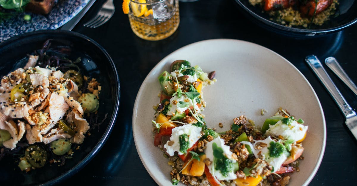 What are the transparent strands in this salad? - Plates filled with tasty meal on table What are the transparent strands in this salad? - Plates filled with tasty meal on table