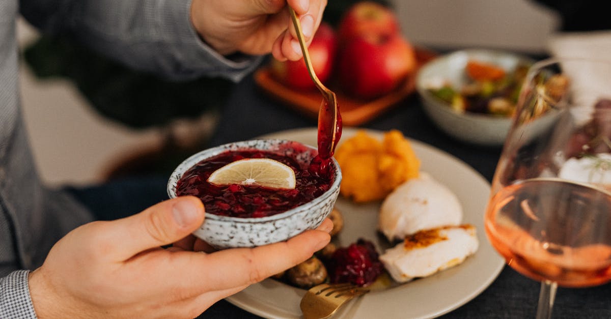 What are the uses of tzatziki sauce? [closed] - Person Holding Stainless Steel Spoon With Red Sauce