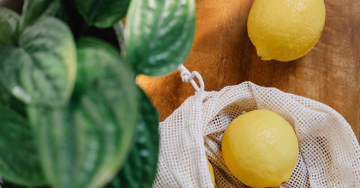 What are these dark green spots inside raw eggs? - Fresh lemons placed on wooden table