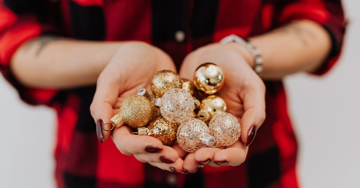What are these little balls in my sardines? - Person Holding Silver and Gold Christmas Balls What are these little balls in my sardines? - Person Holding Silver and Gold Christmas Balls