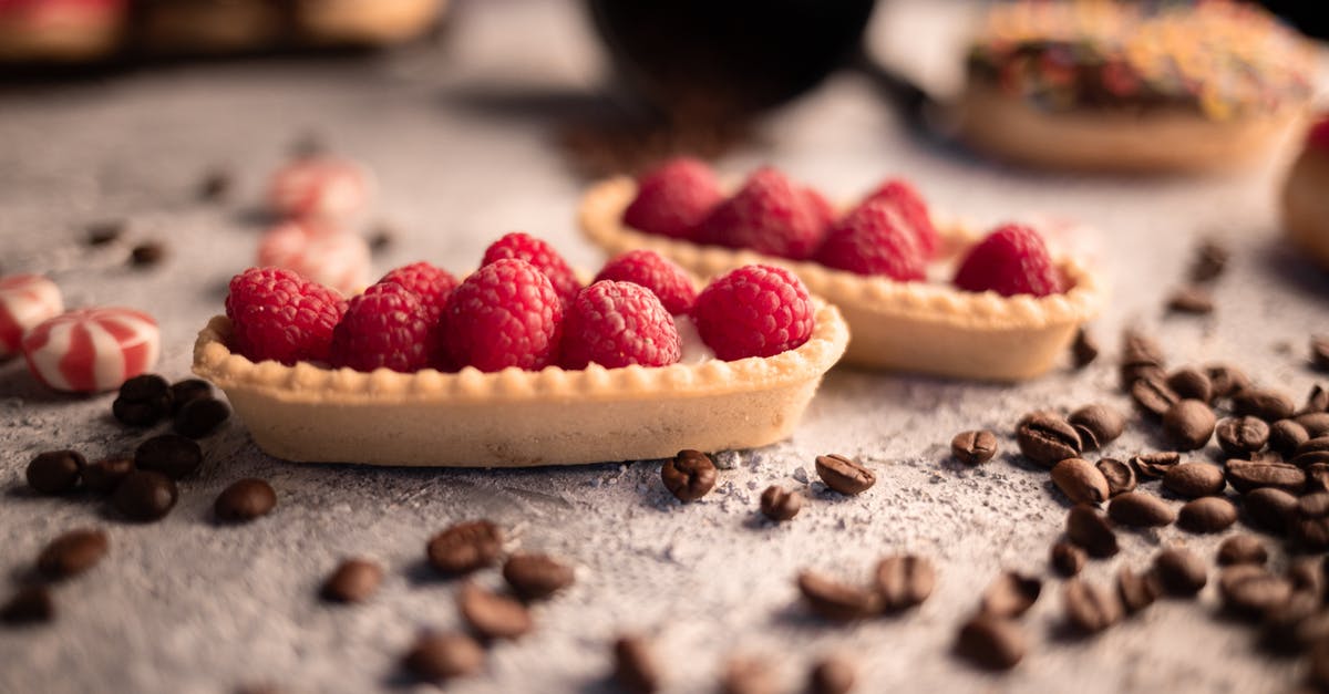 What bean species are best for baked beans? - Delicious fresh raspberry tartlets placed on table amidst aromatic coffee beans and sweets What bean species are best for baked beans? - Delicious fresh raspberry tartlets placed on table amidst aromatic coffee beans and sweets