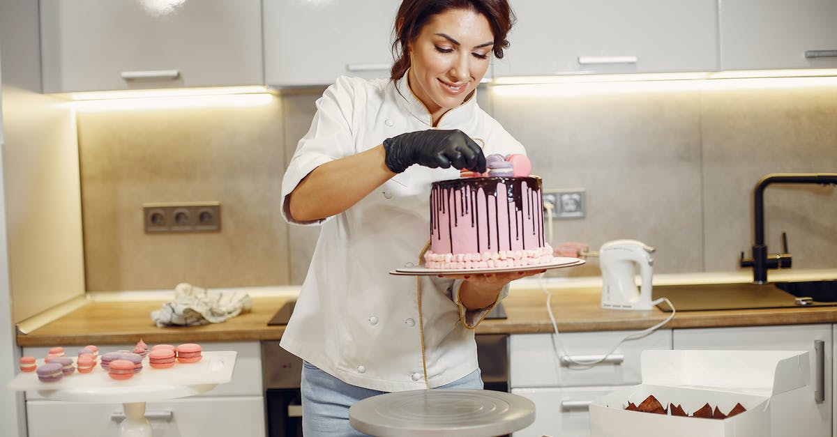What can I do if I forgot to cream the butter and sugar in my cookie recipe? - Smiling female cook decorating cake with delicious macaroons in modern restaurant