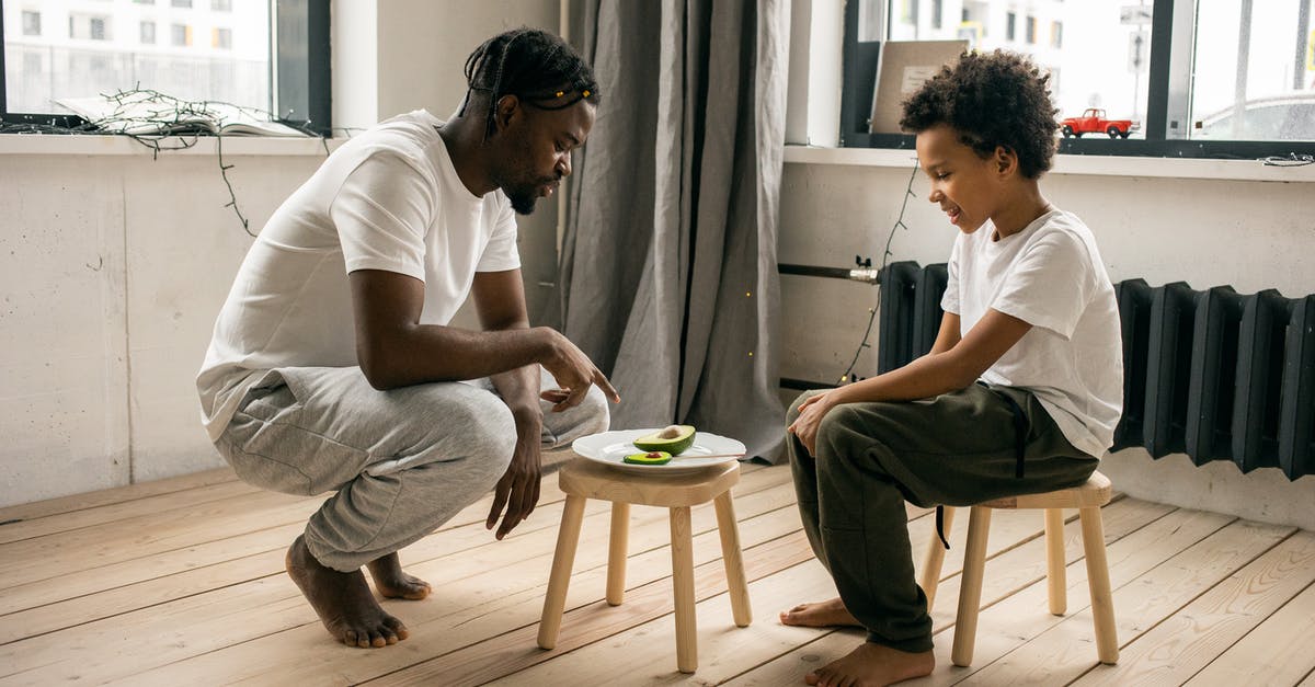 What can I do to help my avocados ripen? - Black father with son near plate with avocados