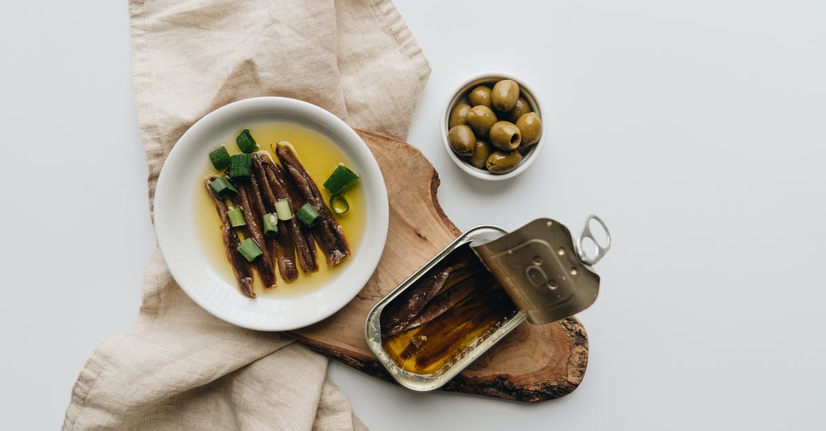 What can I substitute for Gruyère in quiche lorràine? - Close-Up Shot of a Can of Anchovies beside Olives What can I substitute for Gruyère in quiche lorràine? - Close-Up Shot of a Can of Anchovies beside Olives