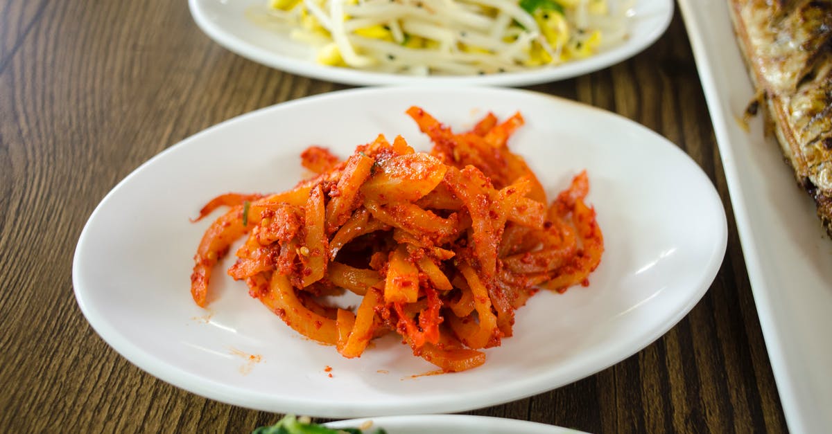 What can I substitute for radish when making kimchi? - Ceramic Plates with Side Dishes on a Wooden Surface What can I substitute for radish when making kimchi? - Ceramic Plates with Side Dishes on a Wooden Surface