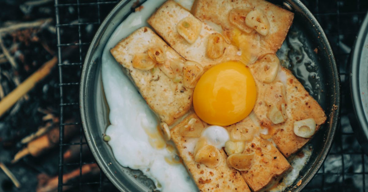 What causes a food to become tough as opposed to crispy or flaky when pan frying or baking? - Appetizing egg toast roasting on pan