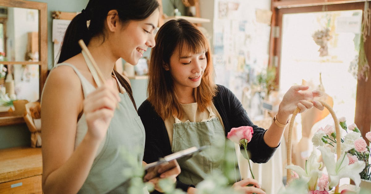 What causes butter to make risotto shiny? - Young glad ethnic female partners creating flower bouquet in basket at table while working in daylight What causes butter to make risotto shiny? - Young glad ethnic female partners creating flower bouquet in basket at table while working in daylight