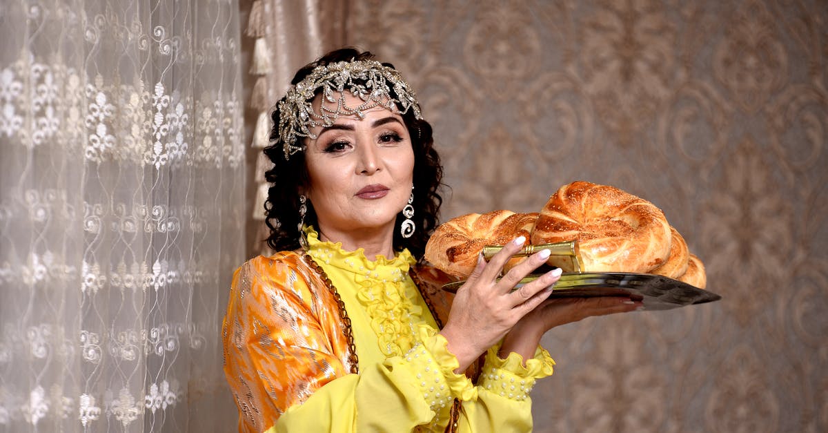 What causes the crown of the bread to crack during baking? - A Woman in Yellow Dress Holding a Tray of Bread What causes the crown of the bread to crack during baking? - A Woman in Yellow Dress Holding a Tray of Bread