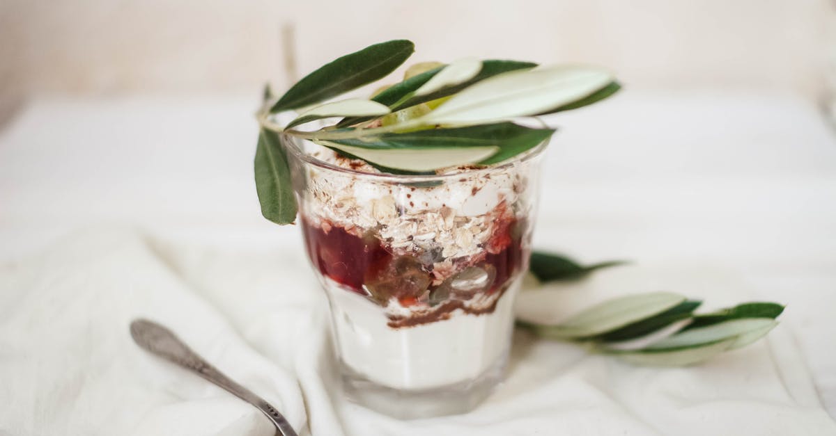 What causes yogurt in sauces to split? How to prevent it? - Delicious dessert in glass with olive leaves What causes yogurt in sauces to split? How to prevent it? - Delicious dessert in glass with olive leaves