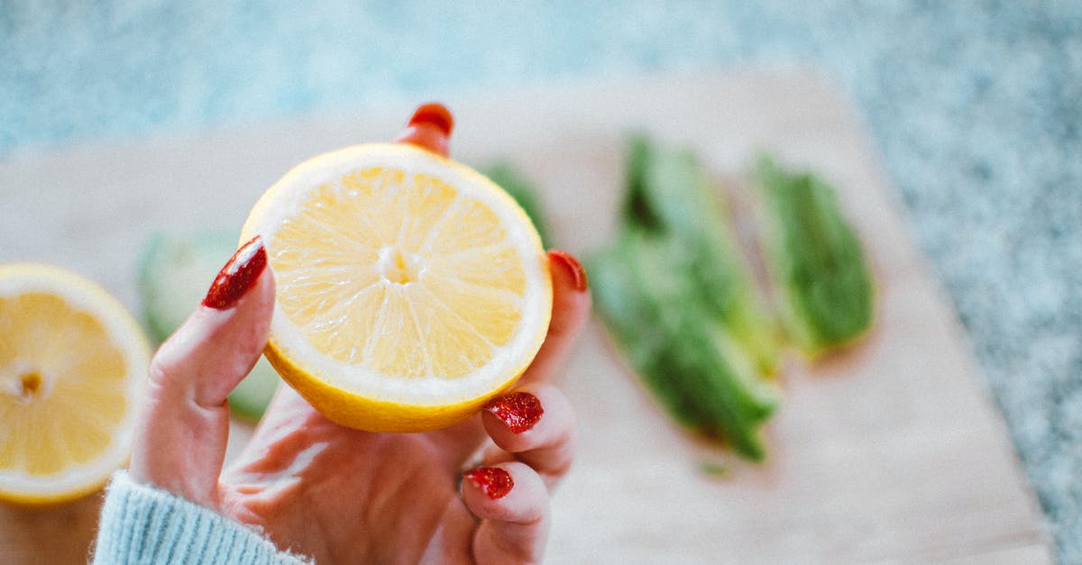 What could be the basic ingredients that potentiate sourness and bitterness? - Selective Focus Photography of Person Holding Sliced Lemon What could be the basic ingredients that potentiate sourness and bitterness? - Selective Focus Photography of Person Holding Sliced Lemon
