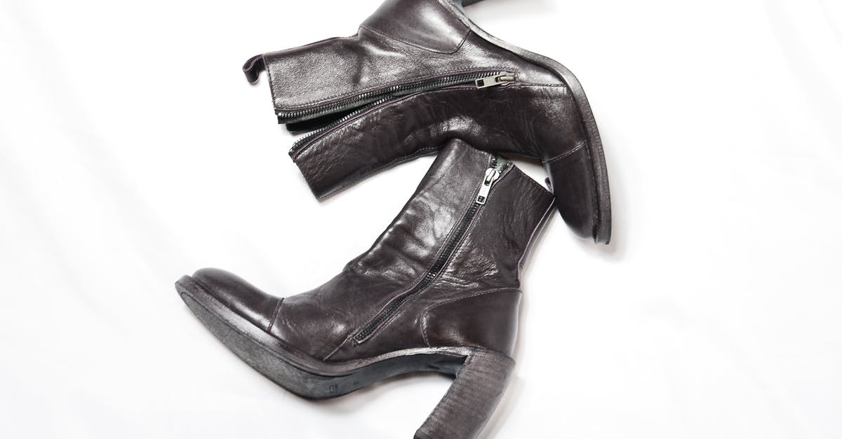 What could this utensil pair be used for? - Top view of pair of dark brown leather boots with zipper and wide high heels placed on white background What could this utensil pair be used for? - Top view of pair of dark brown leather boots with zipper and wide high heels placed on white background