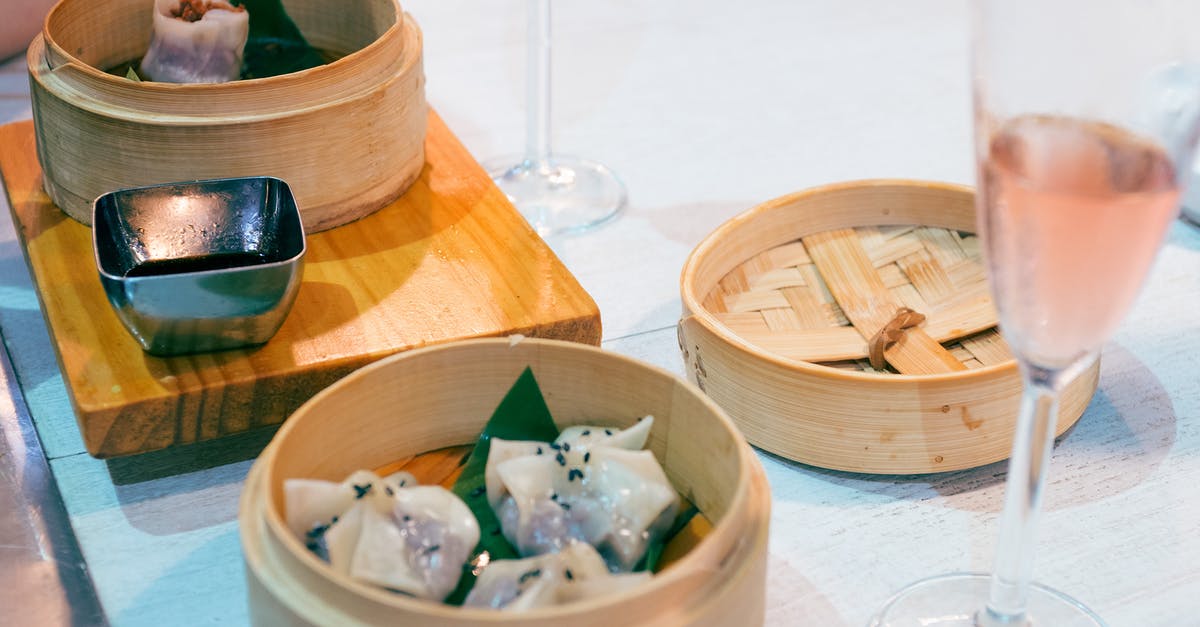 What defines a gui chow dish in Chinese cuisine? - Delicious traditional Asian dim sum dishes in wooden bowls served on table What defines a gui chow dish in Chinese cuisine? - Delicious traditional Asian dim sum dishes in wooden bowls served on table