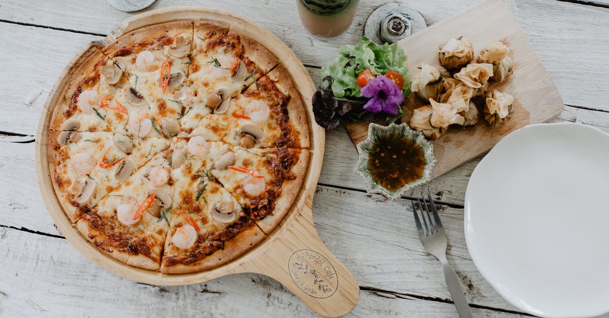 What defines a gui chow dish in Chinese cuisine? - Pizza and dim sum on table in cafe What defines a gui chow dish in Chinese cuisine? - Pizza and dim sum on table in cafe