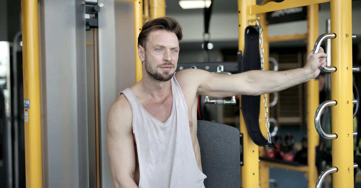 What dishes don't stain with heavy spices? - Serious bearded male athlete in casual sportswear sitting near modern exercise machine during break in workout in modern fitness center and looking away What dishes don't stain with heavy spices? - Serious bearded male athlete in casual sportswear sitting near modern exercise machine during break in workout in modern fitness center and looking away