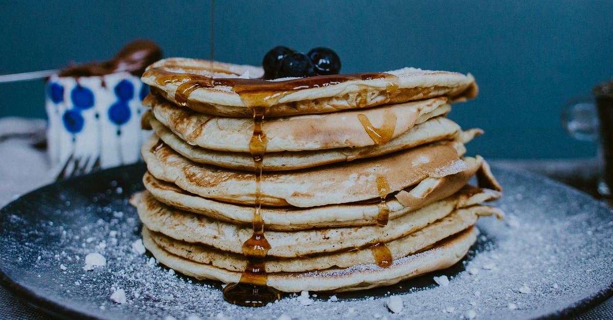 What do I do with mildly fermented maple syrup? - Pile of tasty homemade golden pancakes decorated with fresh blueberries and honey on plate with icing sugar What do I do with mildly fermented maple syrup? - Pile of tasty homemade golden pancakes decorated with fresh blueberries and honey on plate with icing sugar