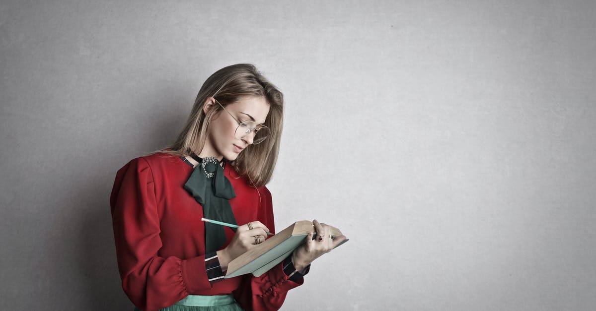What do I search for when looking for unsweetened recipes? - Pensive attentive woman in glasses and elegant vintage outfit focusing and taking notes with pencil in book while standing against gray wall What do I search for when looking for unsweetened recipes? - Pensive attentive woman in glasses and elegant vintage outfit focusing and taking notes with pencil in book while standing against gray wall