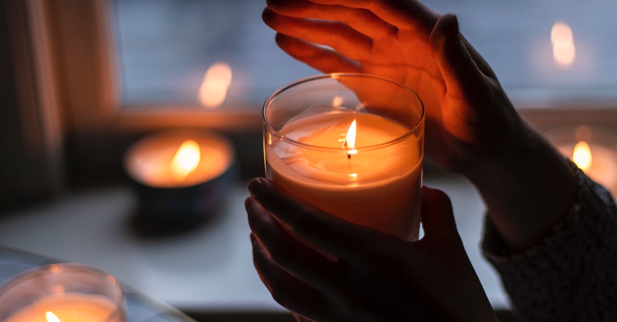 What does a Thai Scented Candle impart? - Photo of Person Holding Scented Candle What does a Thai Scented Candle impart? - Photo of Person Holding Scented Candle