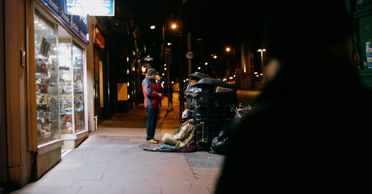 What does adding dark rum give to a fajita stir-fry? - Anonymous man giving money to poor beggar on tiled sidewalk near shop showcases in town at dusk What does adding dark rum give to a fajita stir-fry? - Anonymous man giving money to poor beggar on tiled sidewalk near shop showcases in town at dusk