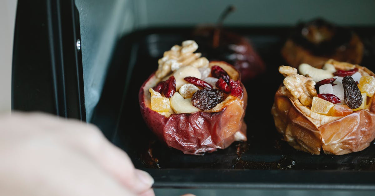 What does North American mixed dried fruit contain? - Crop unrecognizable chef removing baking sheet with appetizing stuffed baked apples from electric oven at home What does North American mixed dried fruit contain? - Crop unrecognizable chef removing baking sheet with appetizing stuffed baked apples from electric oven at home