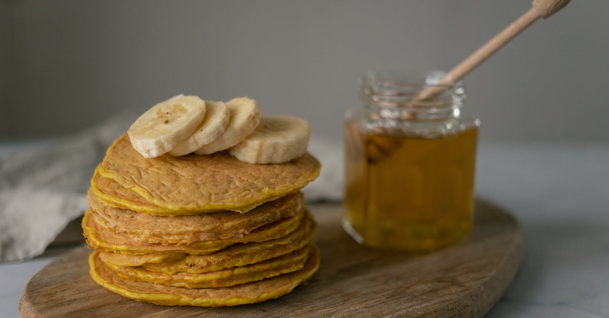 What does "buttermilk" mean in an American pancake recipe? - Tasty homemade pancakes with sliced bananas near jar with honey and wooden spoon on cutting board on table What does "buttermilk" mean in an American pancake recipe? - Tasty homemade pancakes with sliced bananas near jar with honey and wooden spoon on cutting board on table