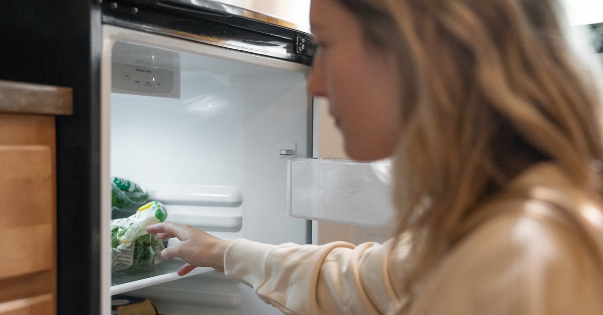 What does the refrigerator crisper compartment actually do? - Woman in Brown Long Sleeve Shirt Holding Green Vegetable What does the refrigerator crisper compartment actually do? - Woman in Brown Long Sleeve Shirt Holding Green Vegetable