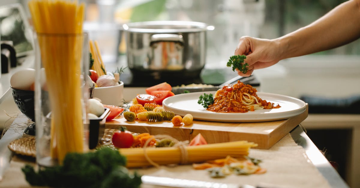 What does vanilla extract add to a recipe? - Crop anonymous chef adding parsley to spaghetti with tomato and meat while cooking lunch in kitchen What does vanilla extract add to a recipe? - Crop anonymous chef adding parsley to spaghetti with tomato and meat while cooking lunch in kitchen