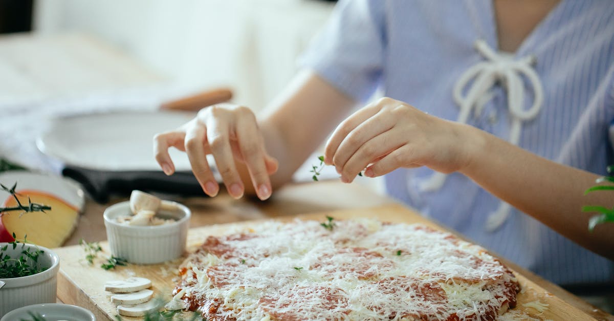What does yeast do to flour? - Woman making pizza in kitchen What does yeast do to flour? - Woman making pizza in kitchen
