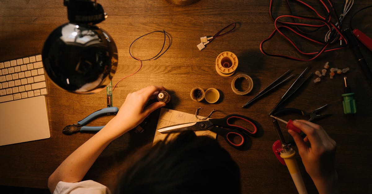 What electronic tools are recommended for a cooking journal? [closed] - Person Holding Pen and Scissors